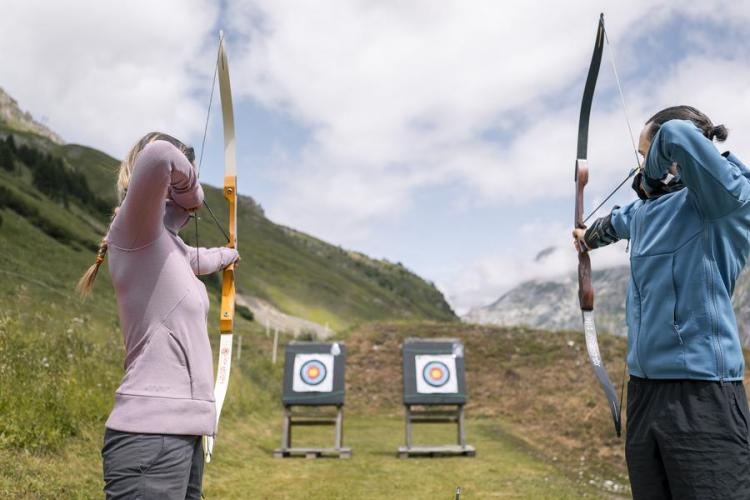 Femme et homme qui font du tir à l'arc à Val d'Isère - Femme et homme qui font du tir à l'arc à Val d'Isère